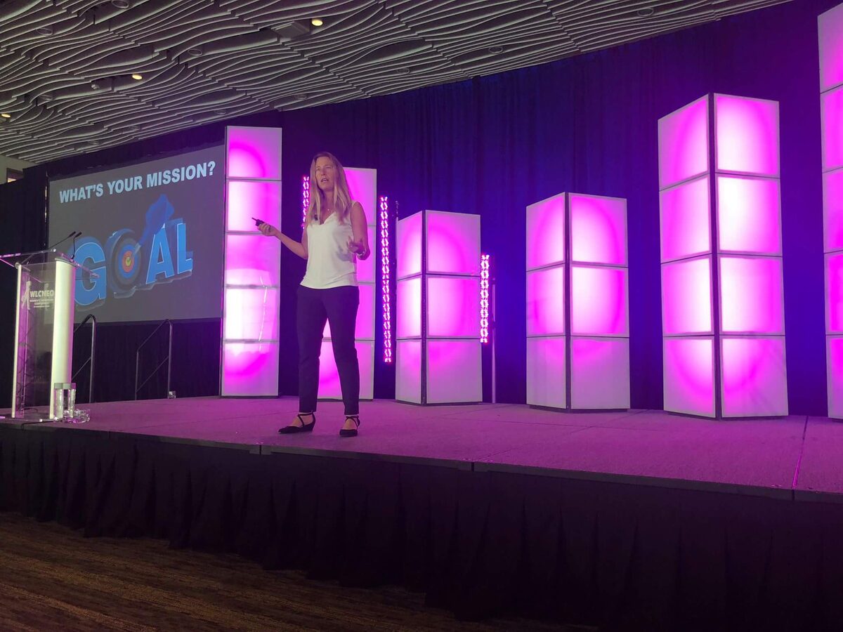 Ilana Golan on stage at the Women's Leadership Conference of Northeast Ohio, asking the audience: What's your mission?