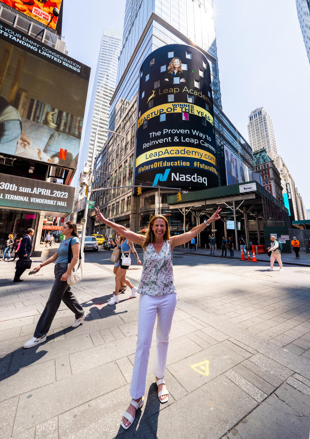 Ilana Golan celebrating below the Nasdaq Tower after Leap Academy was named Startup of the Year