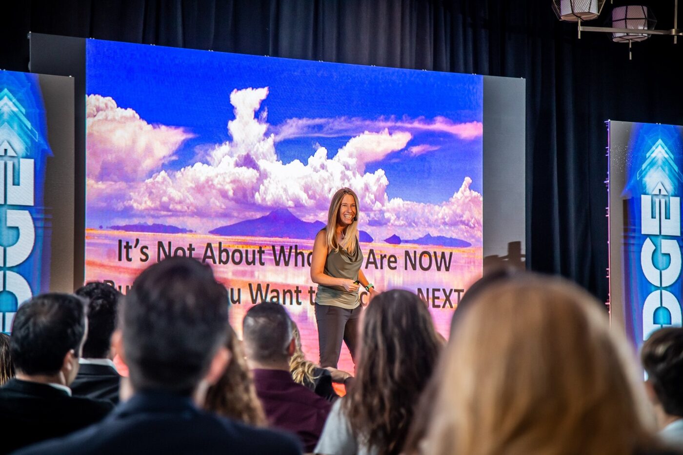 Ilana Golan on stage, screen reading: It's not about who you are now, but who you want to become next